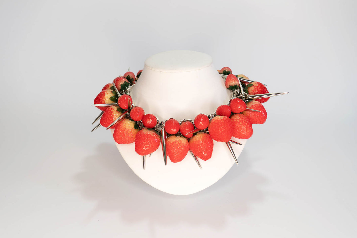 Necklace with strawberries on a white background