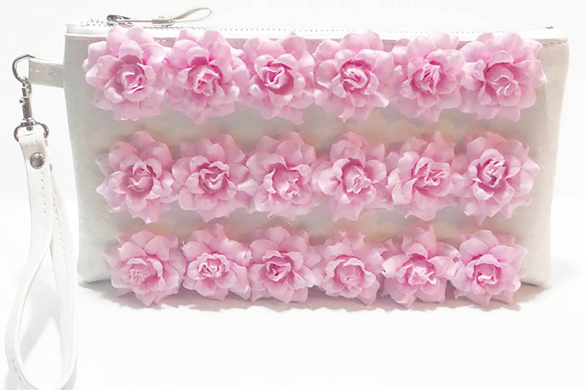 White pouch with pink floral design on a white background