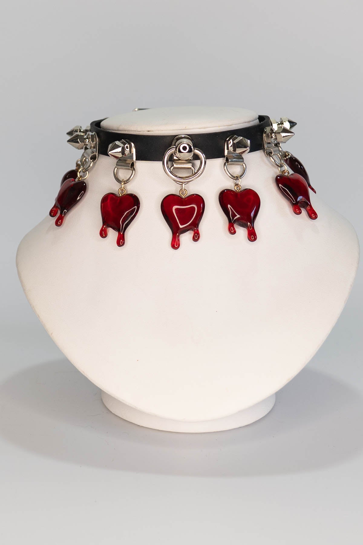 Vase with a black collar and red heart-shaped decorations on a white background