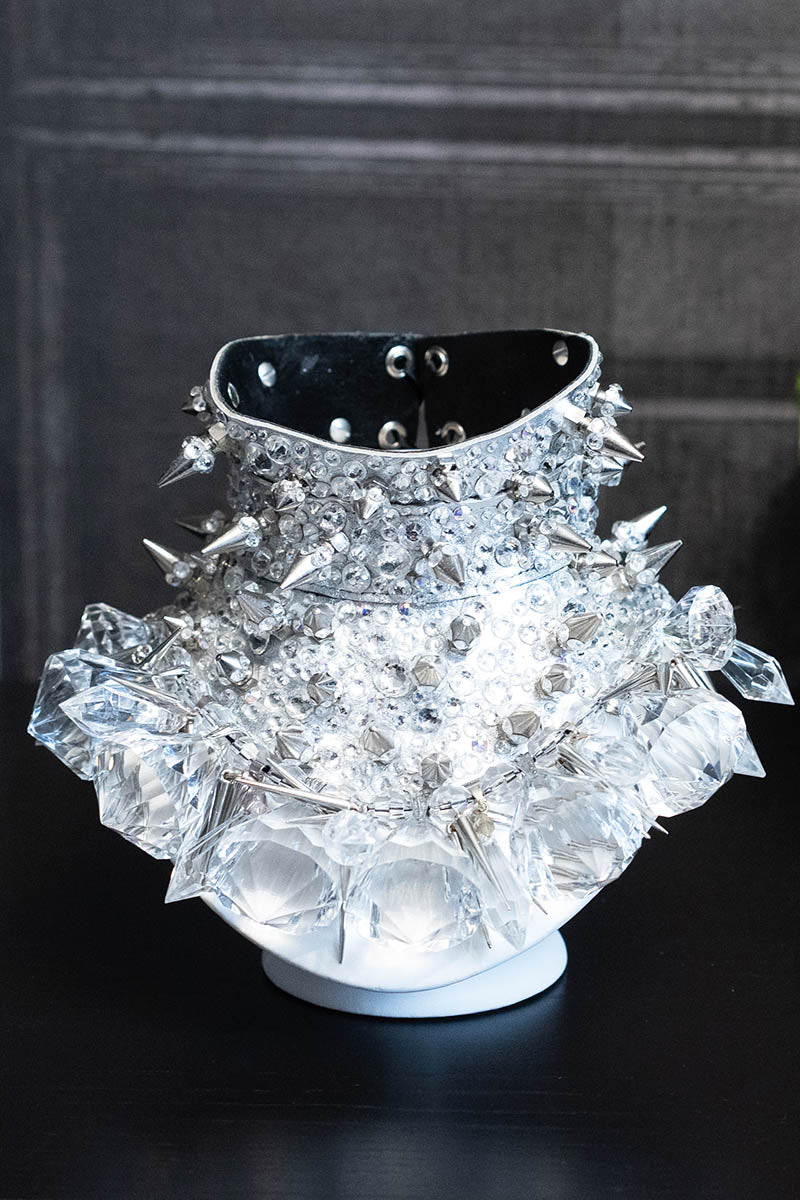 A luxurious silver leather posture collar necklace with black suede lining, adorned with genuine Swarovski crystals and dazzling spikes.