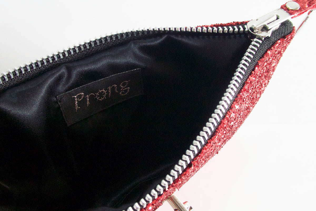 Red glittery pouch with a black interior and 'Prong' branding.