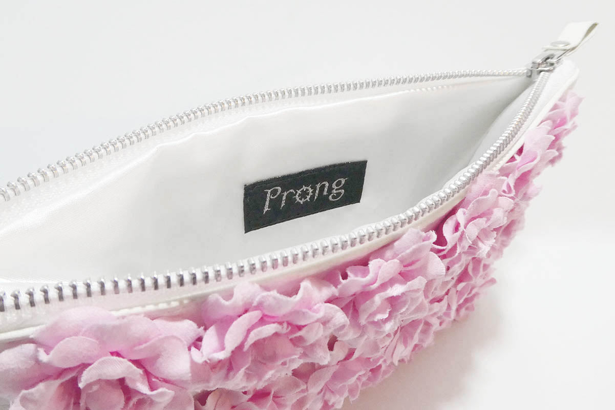 White pouch with pink floral edge and 'Prong' brand label on a white background