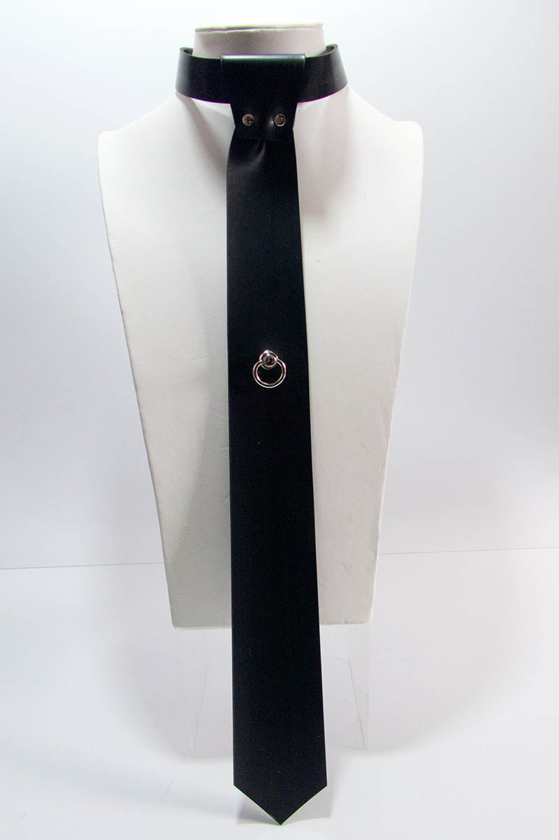 A black skinny tie with a swivel ring mounted on a mannequin's neck.