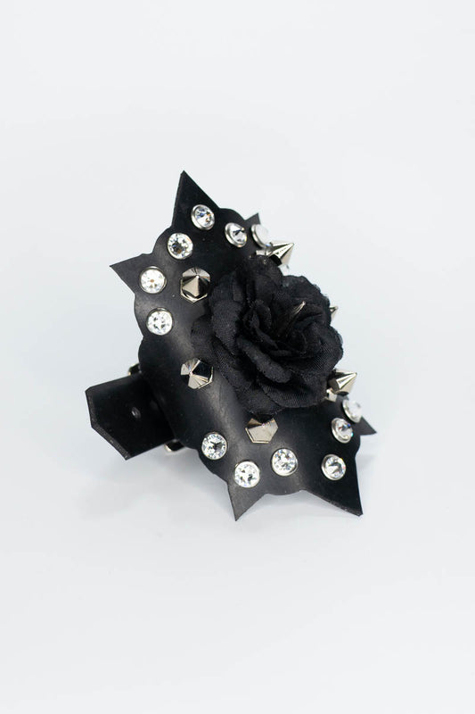 Black rose rubber bracelet with studs and spikes on a white background