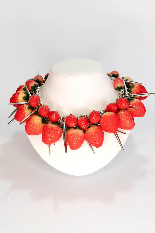 Necklace with strawberries and red berries on a white background