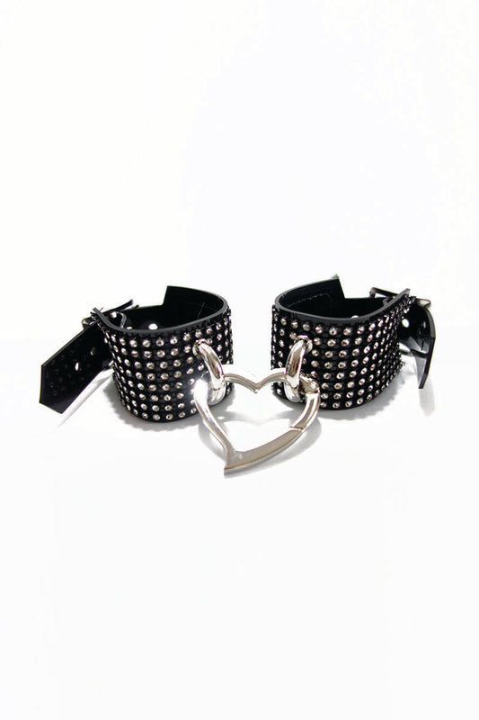 Black diamante bracelets with a heart-shaped clasp on a white background
