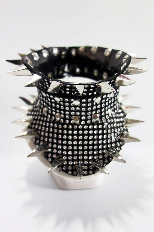 Spiked and studded black and silver posture collar on a white background