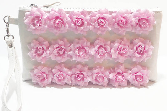 White pouch with pink floral design on a white background