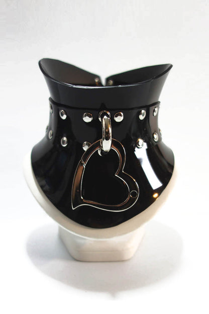 Black and silver glossy pvc posture collar with a heart clip on a white background
