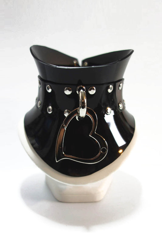 Black and silver glossy pvc posture collar with a heart clip on a white background