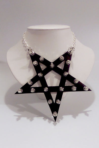Black star-shaped necklace with studs on a mannequin against a white background