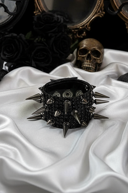 Black diamante mesh cuff bracelet with rows of black gun-metal color spikes and a fastening press stud.