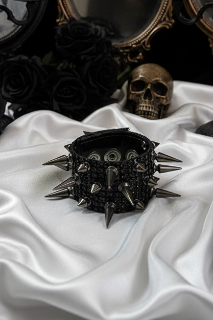 Black diamante mesh cuff bracelet with rows of black gun-metal color spikes and a fastening press stud.