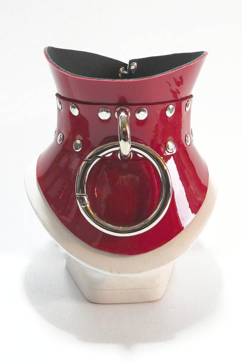 Red and white decorative item with a circular handle on a white background