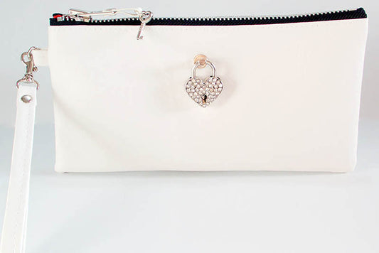 White clutch bag with a heart-shaped clasp on a light gray background
