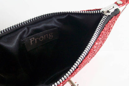 Red glittery pouch with a black interior and 'Prong' branding.