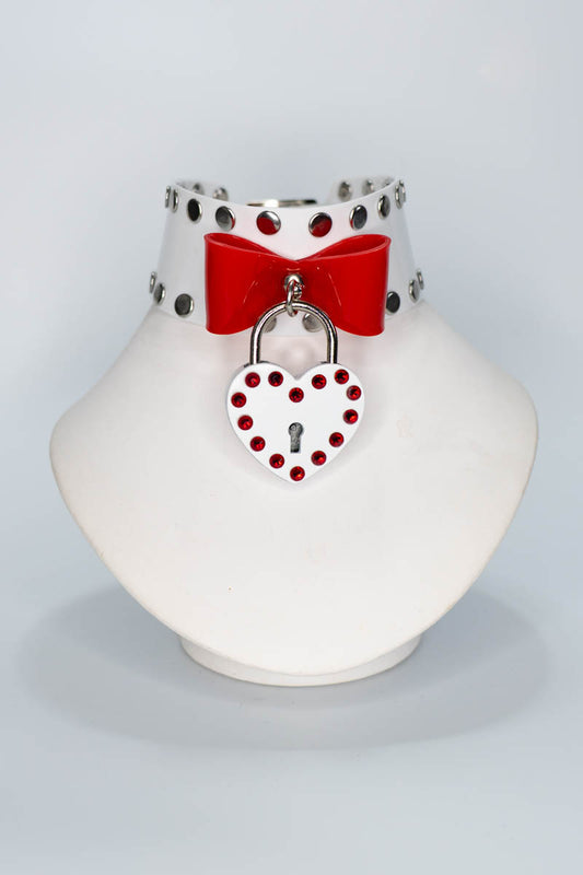 Decorative collar with red bow and heart-shaped lock on a white stand against a light gray background