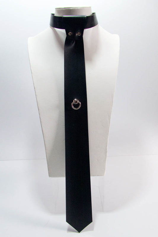A black skinny tie with a swivel ring mounted on a mannequin's neck.