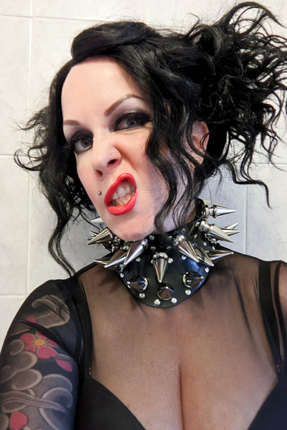edgy statement necklace on a black haired irl with bright red lipstick